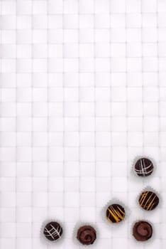Brown Truffle Chocolates on a White Braided Background