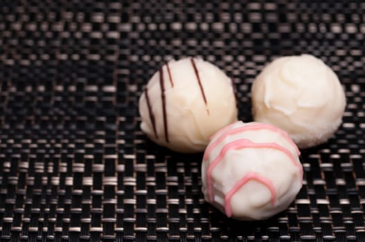 Three White Truffle Chocolates Dark Fabric