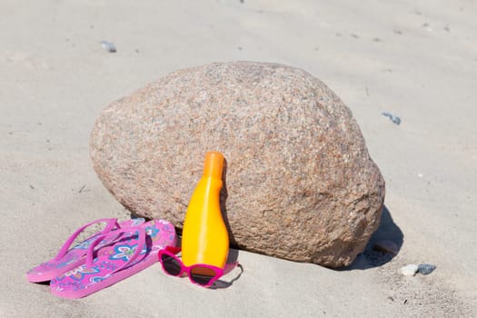 Flip-flops on the beach with sunglasses