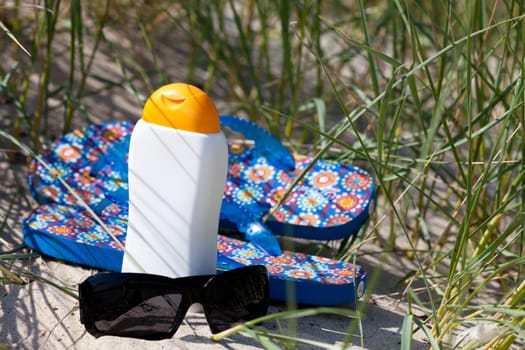 Flip-flops and sunglasses in the dune