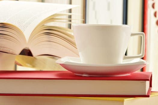 Composition with stack of books and cup of coffee
