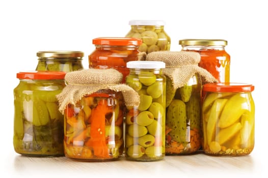 Composition with jars of pickled vegetables. Marinated food.
