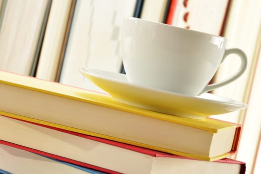 Composition with stack of books and cup of coffee