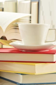 Composition with stack of books and cup of coffee
