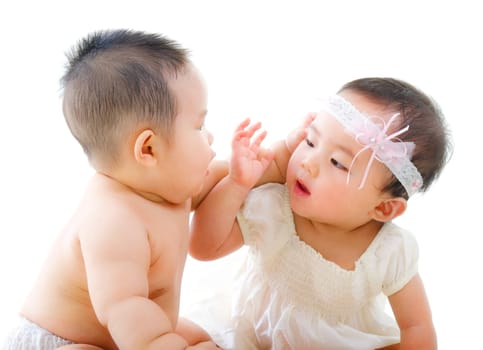 Two Asian babies having baby talk