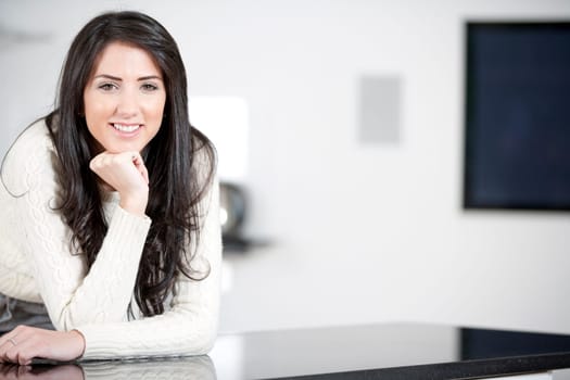 Young woman relaxing in the kitchen at home