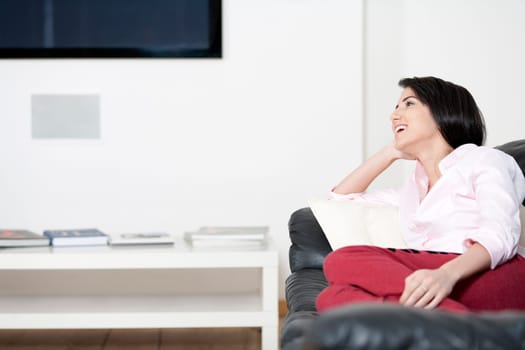 Young woman lying on sofa at home