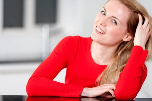 Young woman relaxing in the kitchen at home