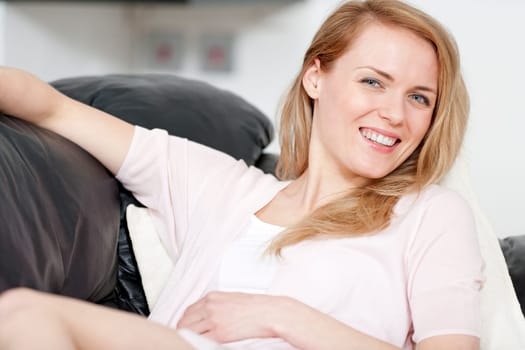 Young woman lying on sofa at home
