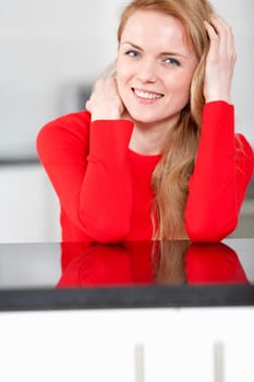 Young woman relaxing in the kitchen at home
