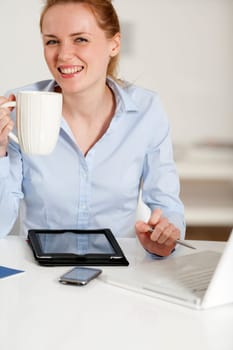 Young woman working at her desk in the office