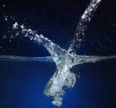 Pouring water  Splash image on a blue background