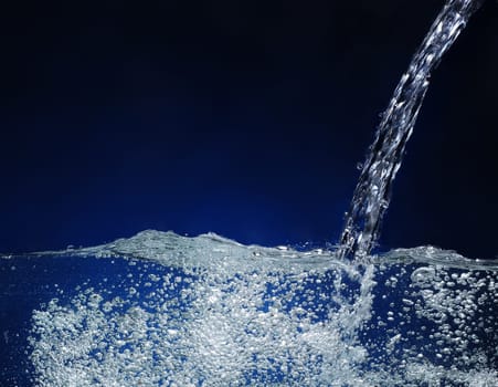 Pouring water  Splash image on a blue background