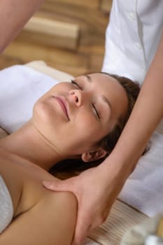 Woman getting neck massage at luxury spa centre