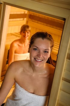 Sweaty brunette woman leaving sauna luxury spa center