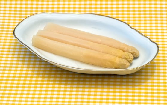 white asparagus from Navarra Spain, presented in decorated ceramic bowl on a tablecloth