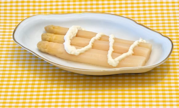 white asparagus from Navarra Spain, presented in decorated ceramic bowl with mayonnaise sauce