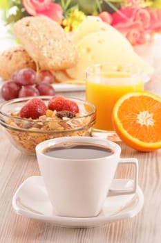 Breakfast on the table. Coffee, orange juice, rolls, muesli.