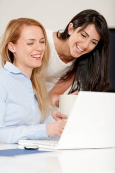 Two colleagues working in an office discussing business