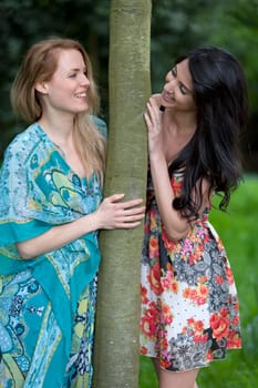 Two friends messing around in a field in summer time