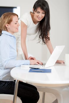 Two colleagues working in an office discussing business