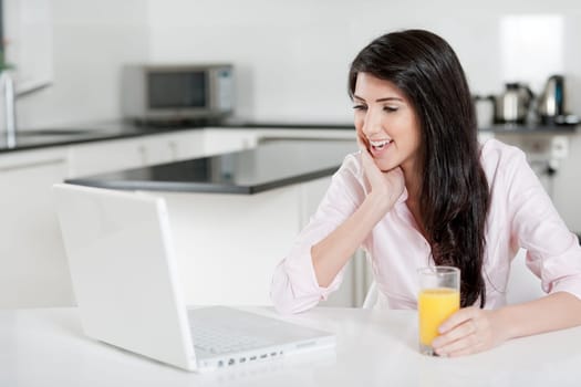 Girl using laptop at home to chat with friends