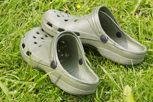 green rubber sandals on a green grass