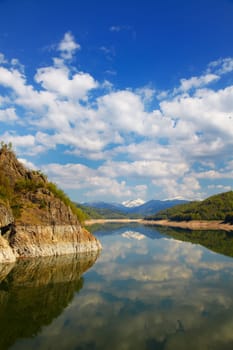 Beautiful landscape of Vidraru lake on a very peaceful day, Romania.
