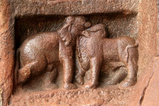 Skillfully sculpted elephant and bull bas relief work at first cave in Badami, Karnataka, India, Asia