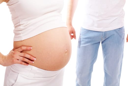 Image of pregnant woman showing her belly with husband on background