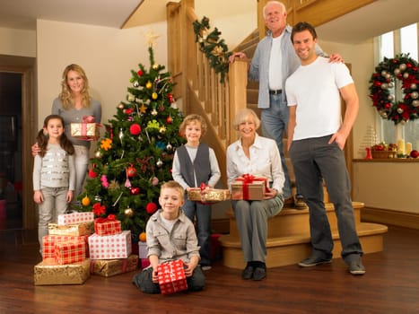 Family with gifts around the Christmas tree