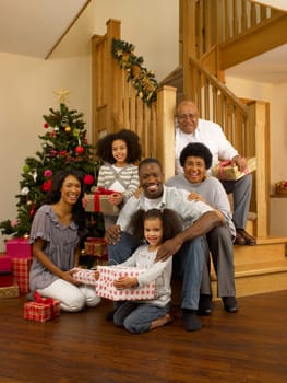African American family with Christmas tree and gifts