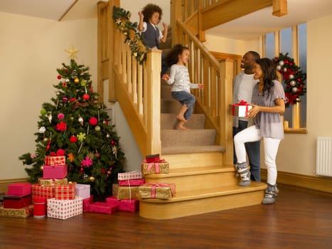 Young mixed race family on Christmas morning