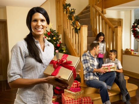 Hispanic family exchanging gifts at Christmas