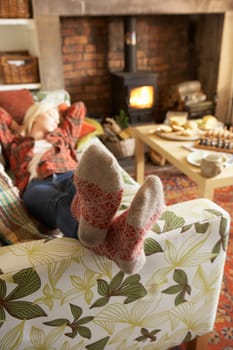 Young woman relaxing by fire
