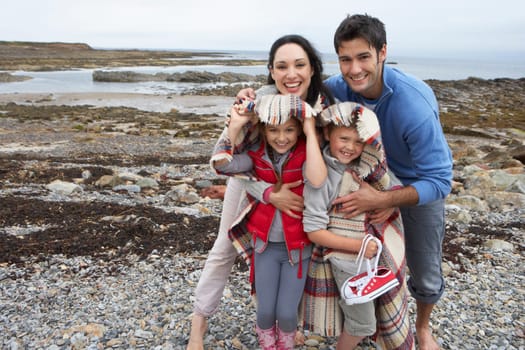 Family on beach with blankets
