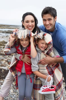 Family on beach with blankets
