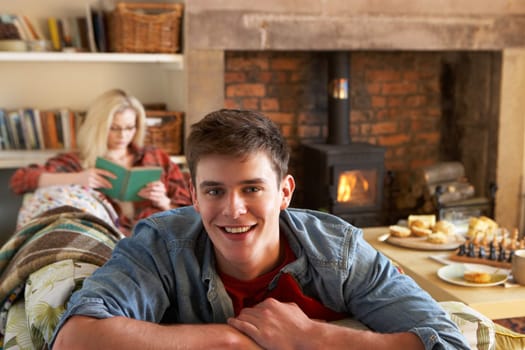 Young couple relaxing by fire