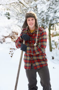 Young man clearing snow