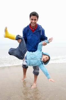 Happy father with son on beach