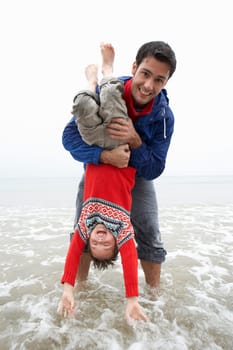Happy father with son on beach