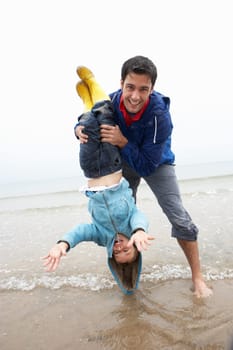 Happy father with son on beach