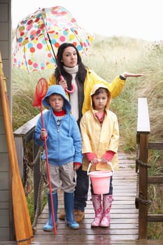 Sad mother and children on beach