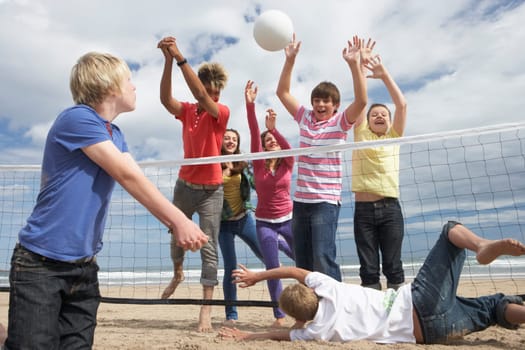 Teenagers playing volleyball