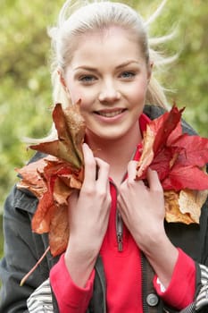 Young woman with autumn leaves