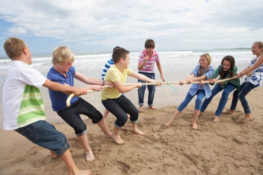 Teenagers playing tug of war