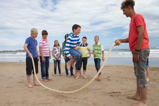 Teenagers playing skipping rope
