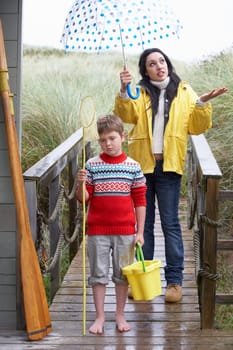 Sad woman and child with umbrella