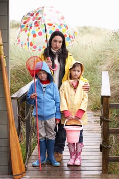 Sad mother and children on beach