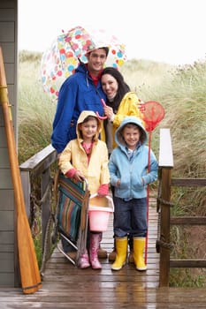 Family on beach with umbrella